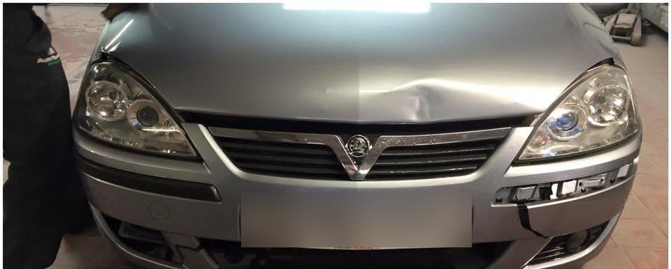 Silver Vauxhall Corsa with a dented wing, cracked bumper and damaged headlight after a front end knock